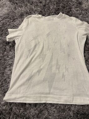 Parker White sheer Tee with subtle lightning bolts on front. Size small
